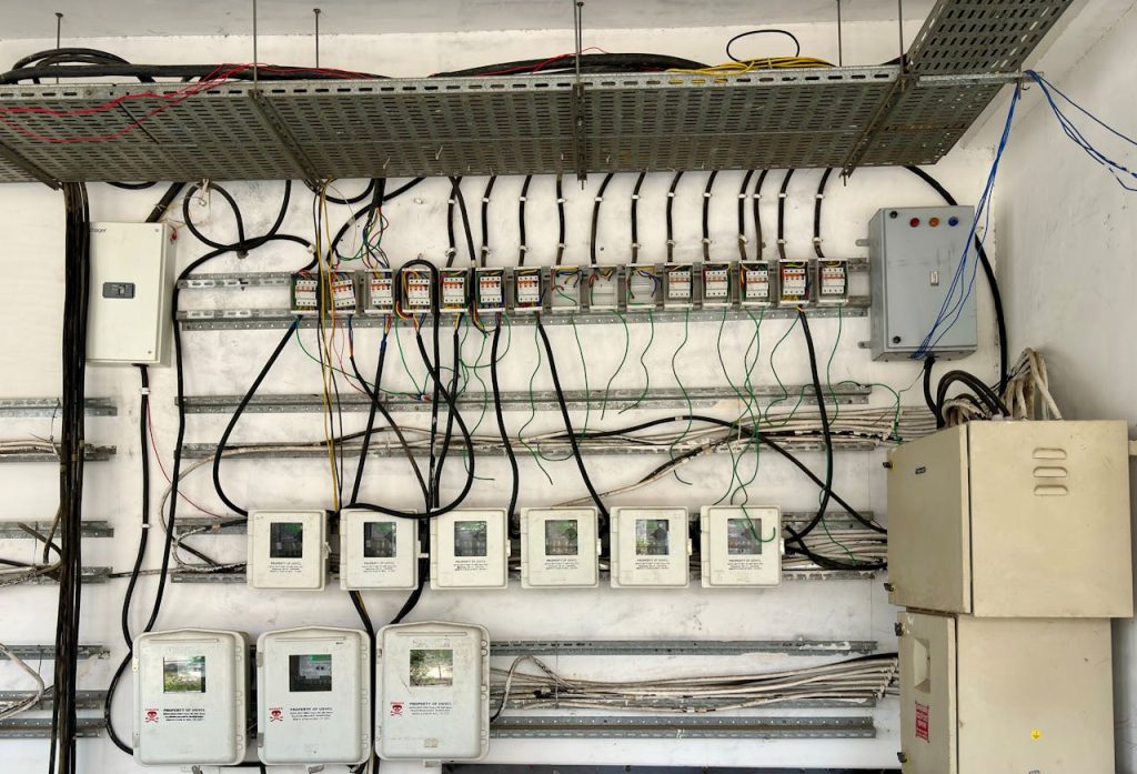 NR Electric Job 1 Complex network of electrical wiring and control panels in an industrial setting.